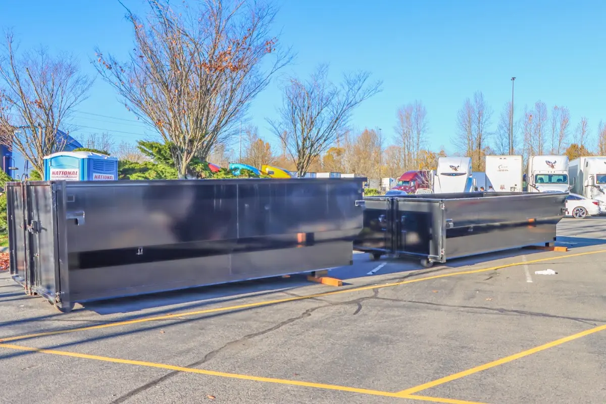 Professional dumpster rental service with roll-off container on residential driveway in New York